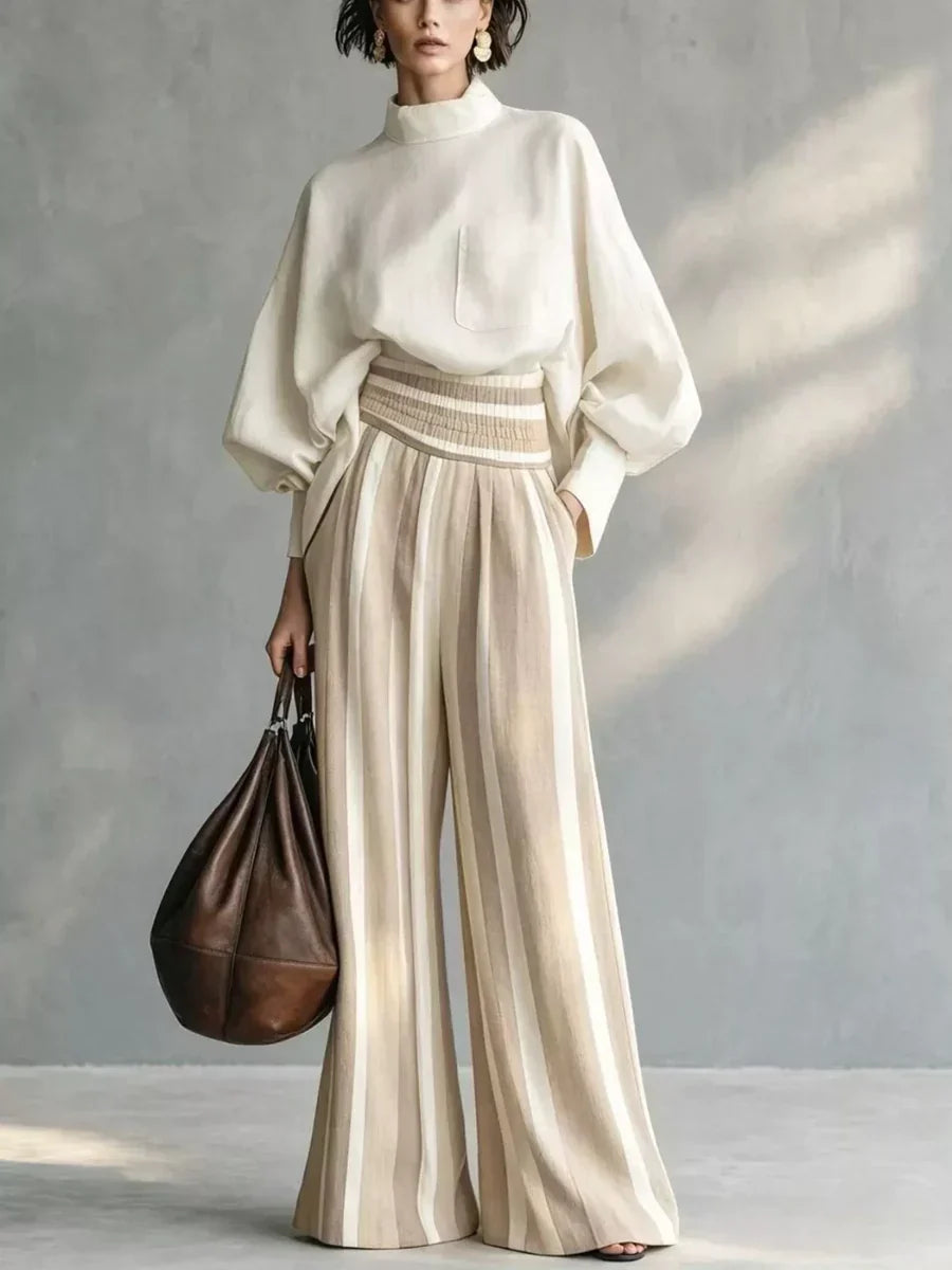 Completo donna elegante con top a collo alto e pantaloni palazzo a righe