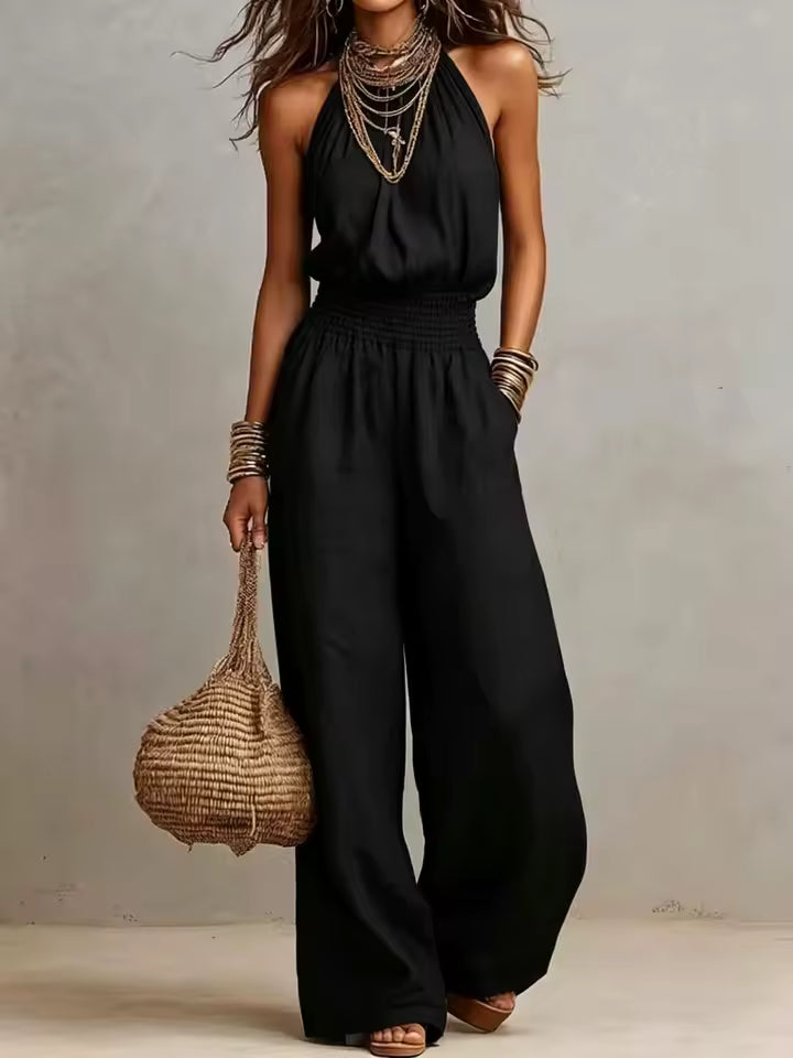 Tuta donna elegante con scollo halter e pantaloni larghi